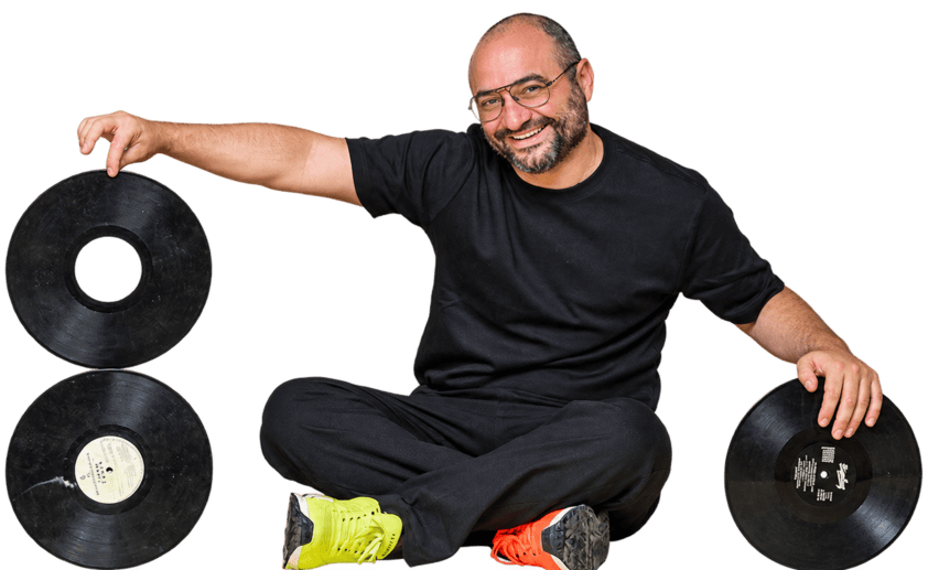 Zak Dakkash seated with vinyl records